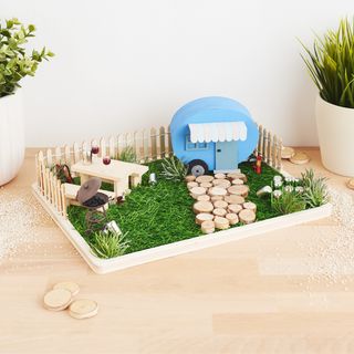 Miniaturn&iacute; sc&eacute;na karavanu na podnosu